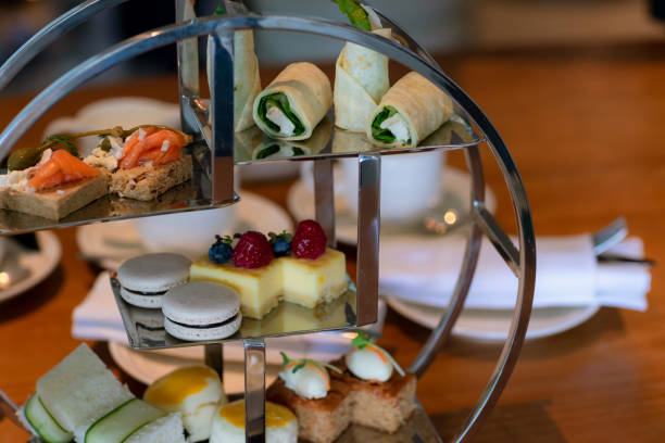 istock afternoon tea and dessert. afternoon tea set,high tea set with dessert. Bakery set in stainless stand. English afternoon tea set , pastry, scones, sandwiches and mini pies. 1275399099