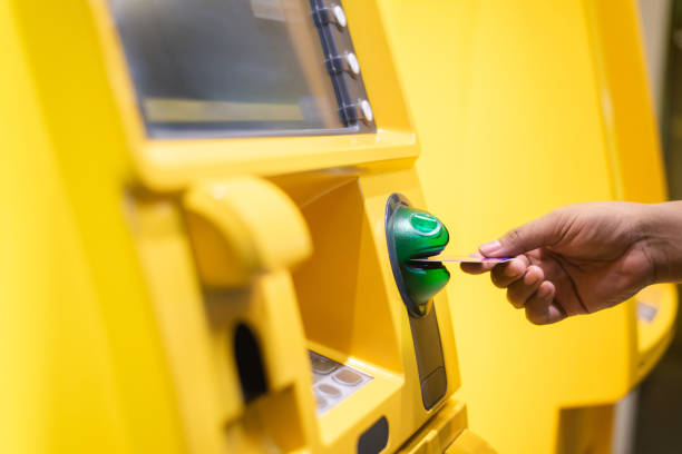 istock Man's Hand Using Card To Withdraw Money 1275407122