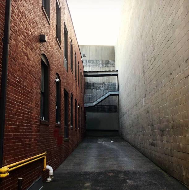 View Down an wide alleyway with Zig-zag stairway at the End stock photo