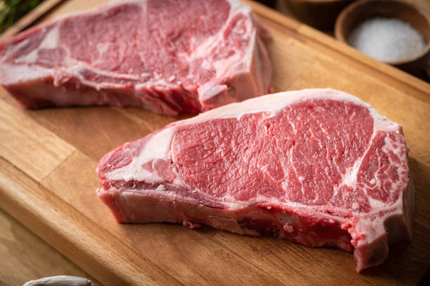 istock raw steak meat on cutting board in bright kitchen 1275412363
