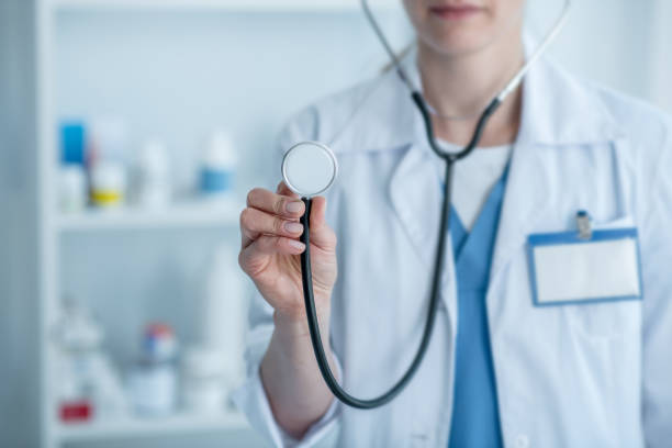 istock Doctor in a white lab coat holding a stethoscope 1275427399