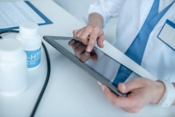 istock Close up of a doctors hands touching the touchpad 1275433016