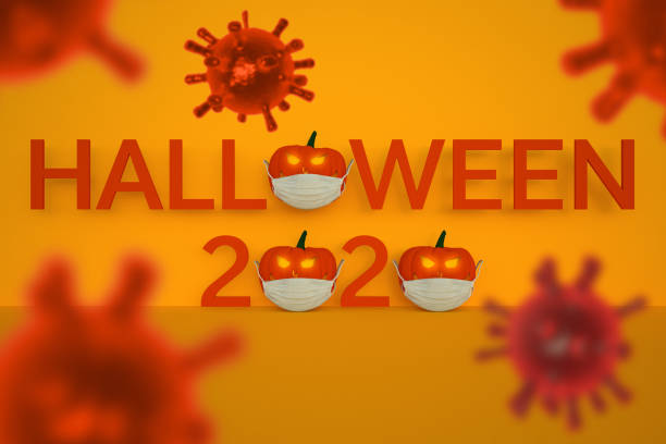 Halloween 2020 text with Jack O'Lantern wearing a protective face mask - Covid-19 virus in the foreground