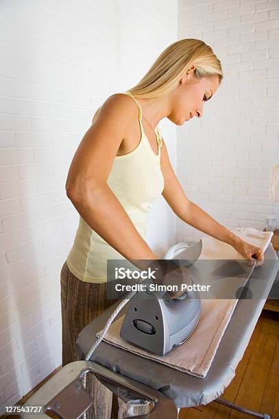Woman Ironing Pants Stock Photo - Download Image Now - 30-34 Years, 30-39 Years, Accuracy