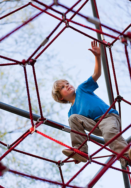 Boy climbing at playground  jungle gym stock pictures, royalty-free photos & images