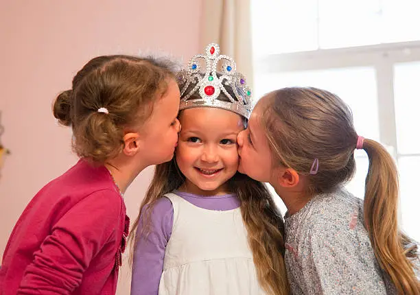 Photo of Girls kissing friendÂs cheeks