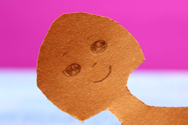 istock close-up paper girl on pink background 1275444352