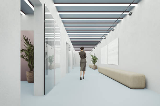 istock Businesswoman walking in office corridor 1275446059