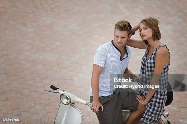 Couple Sitting On Scooter Together Stock Photo - Download Image Now - 18-19 Years, 25-29 Years, Adult