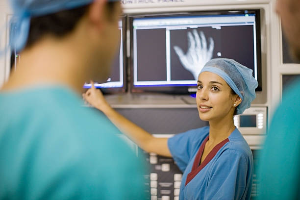 Nurse examining x-ray of hand  examining x ray stock pictures, royalty-free photos & images