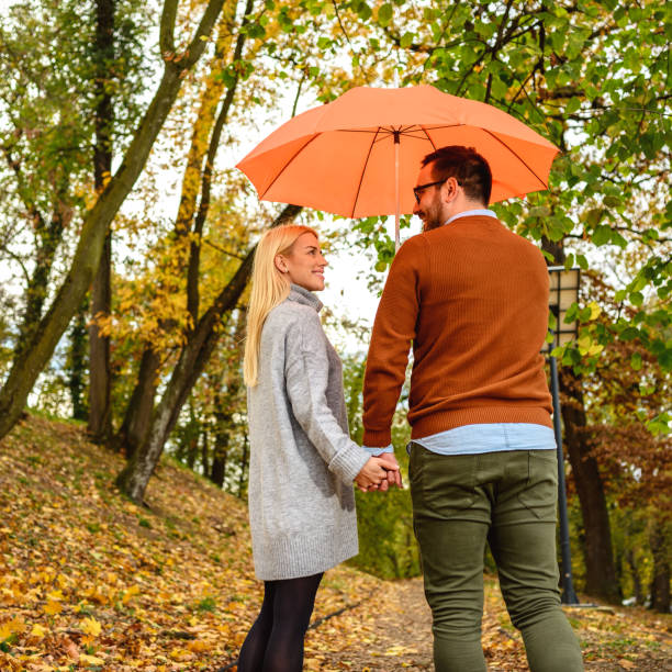 istock Couple in love enjoy in autumn rain. 1275457743