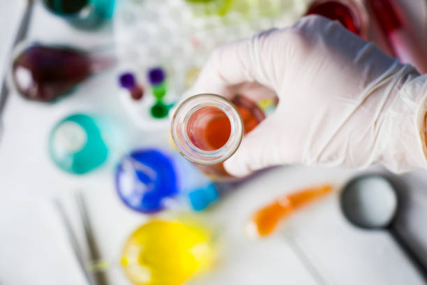 istock Laboratory instruments, glassware and reagents, colorful liquid chemical elements, research diagnoses, doctors hand with glove 1275463315