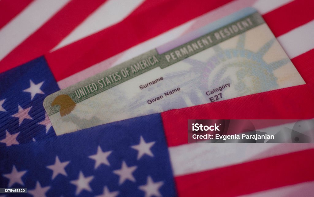 Permanent Resident Green card  of United states covered of flag of USA. Green Card Stock Photo
