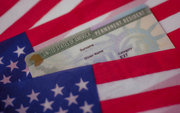Permanent Resident Green card  of United states covered of flag of USA. stock photo