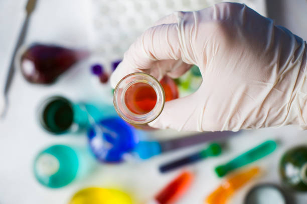 istock Laboratory instruments, glassware and reagents, colorful liquid chemical elements, research diagnoses, doctors hand with glove 1275469493