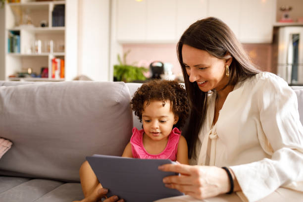 istock Mother and daughter on video call on tablet computer 1275497052