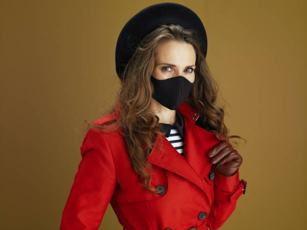istock trendy female in red coat isolated on brown background 1275500846