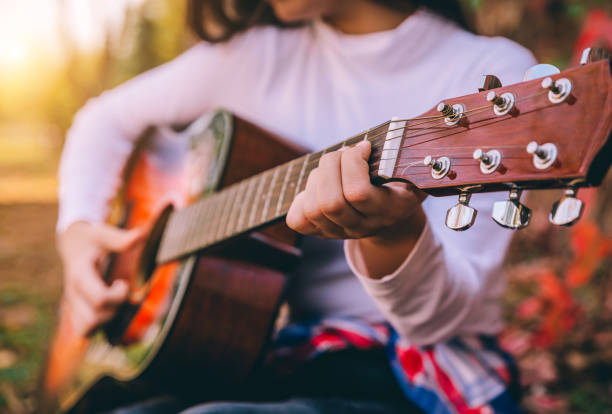 istock Playing guitar in the nature 1275502091