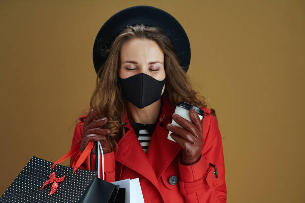 istock woman in red coat against beige background 1275503916