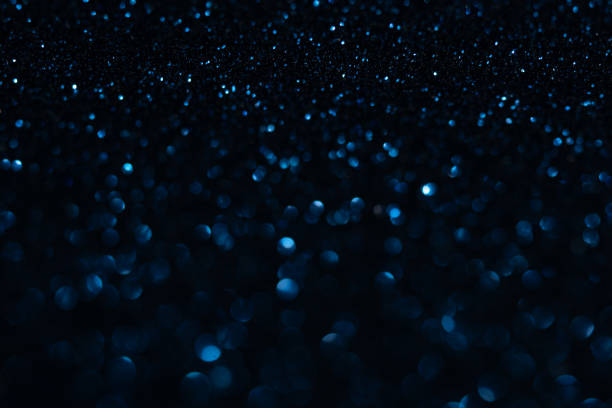istock Blurry colored Christmas holiday lights on a black background. 1275504579