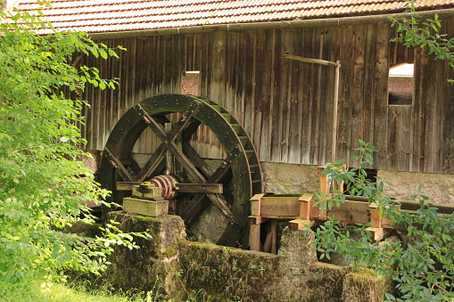 Working watermill wheel with falling water