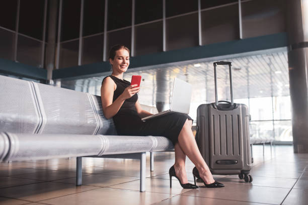 istock Business lady dealing with urgent tasks before a flight 1275518596
