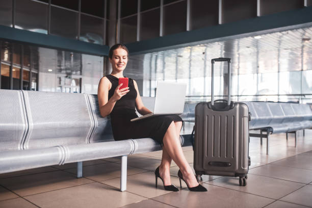 istock Business woman managing tasks while waiting for a flight 1275519095
