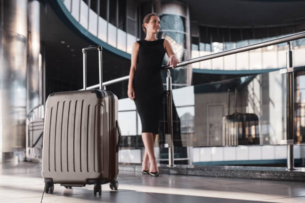 istock Large and convenient suitcase accompanies a woman while travelling 1275522013