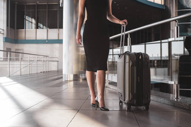 istock Woman walking through a railway station with a suitcase 1275522502