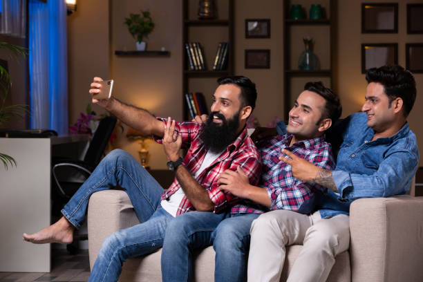 istock Excited Group Of Friends Sitting On Sofa 1275536727