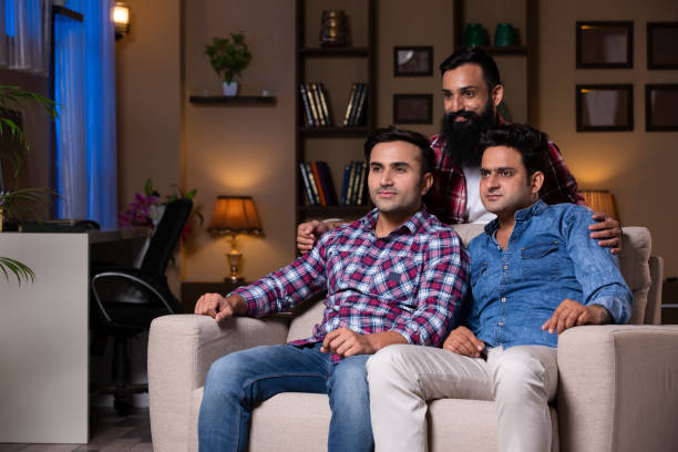 istock Excited Group Of Friends Sitting On Sofa 1275537303