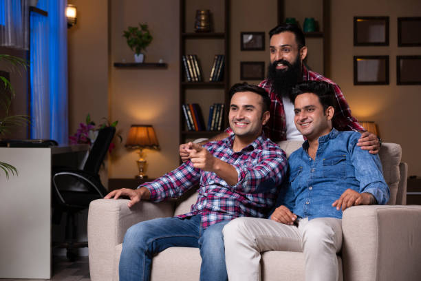 istock Excited Group Of Friends Sitting On Sofa 1275537349
