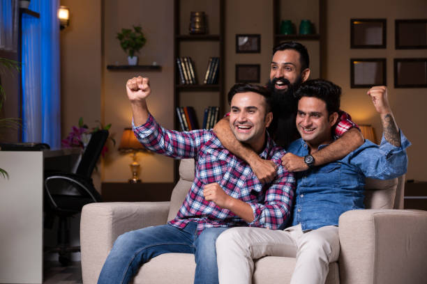 istock Excited Group Of Friends Sitting On Sofa 1275538327
