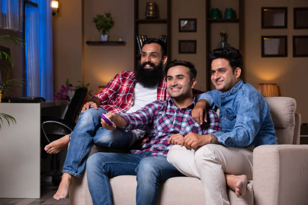 istock Excited Group Of Friends Sitting On Sofa 1275539010