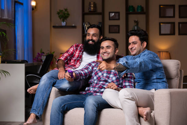 istock Excited Group Of Friends Sitting On Sofa 1275539832