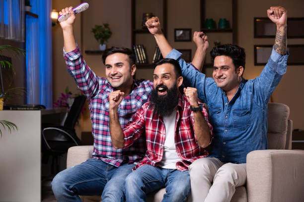 istock Excited Group Of Friends Sitting On Sofa 1275540697