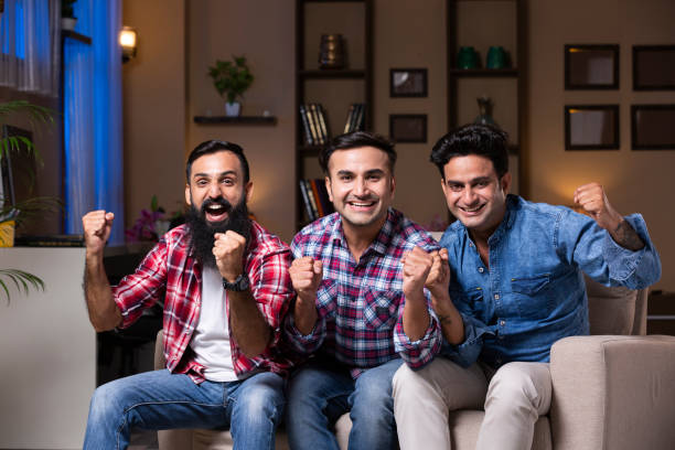 istock Excited Group Of Friends Sitting On Sofa 1275542346