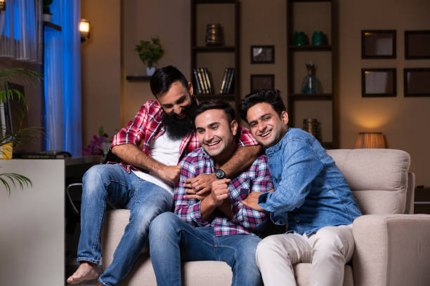 istock Excited Group Of Friends Sitting On Sofa 1275542411