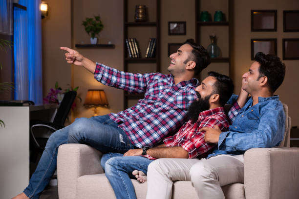 istock Excited Group Of Friends Sitting On Sofa 1275542443