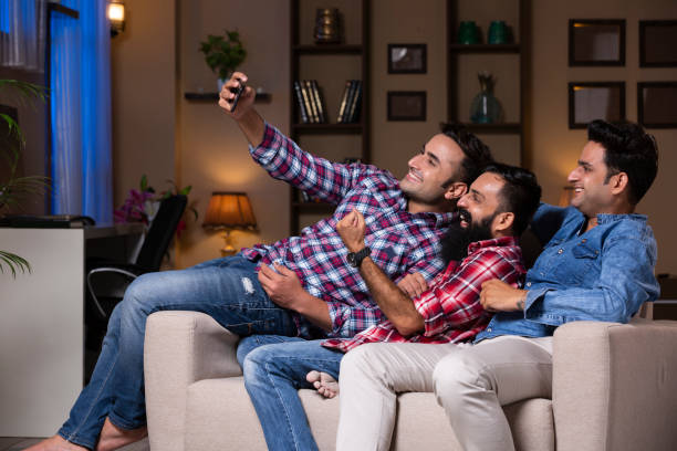 istock Excited Group Of Friends Sitting On Sofa 1275542493