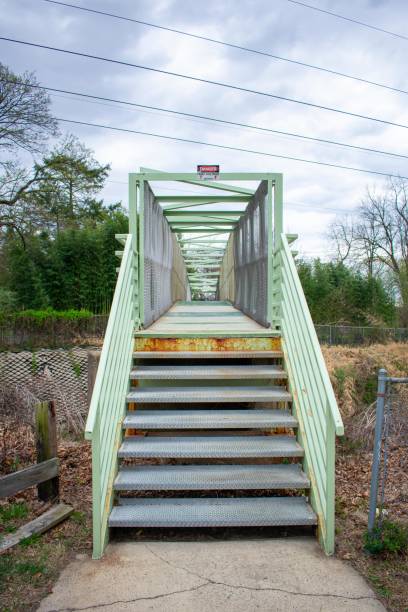 istock A Green Metal Bridge Over a Railroad With a High Voltage Sign 1275543469