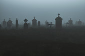 istock Spooky graveyard at night 1275559022