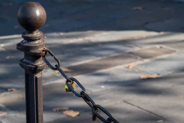 Photo of Padlocks attached to a chain in the streets