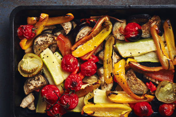 istock Roasted sliced vegetables on a baking tray. 1275570305