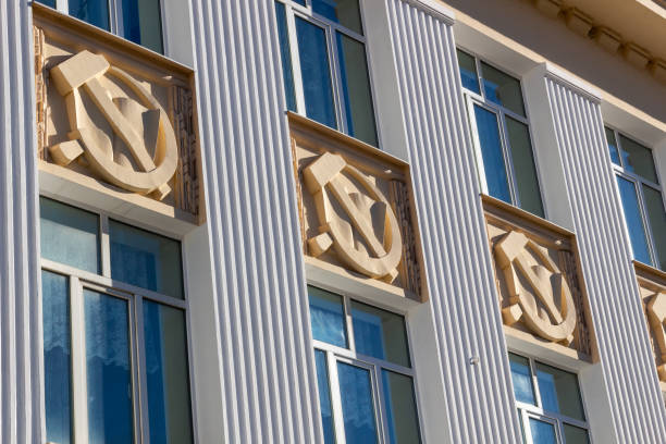 istock hammer and sickle symbol on building facade with windows and columns in sun light 1275580705