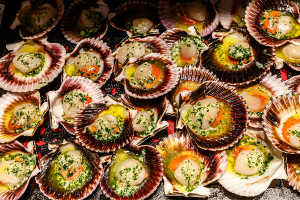 istock Scallops in shells with herbs and seasonings are grilled 1275589269