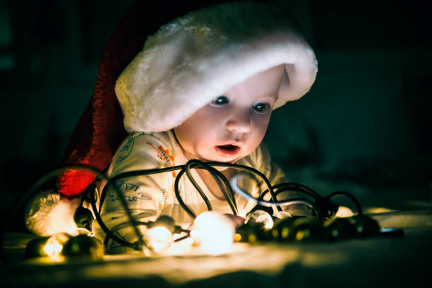 istock Baby with Christmas lights 1275606251