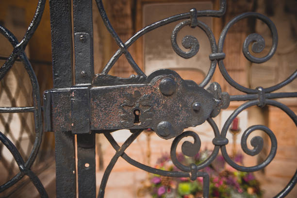istock Lock and gate in front of a grave- 1275608613