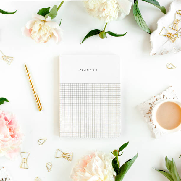 istock Workspace with diary, notebook, accessories, peony flowers on white background. Home office desk. Top view feminine background. Flat lay, top view 1275612301