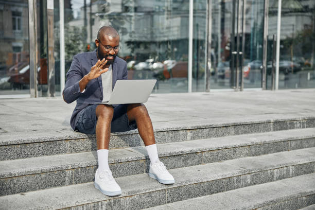 istock Positive delighted young man having video call 1275617237
